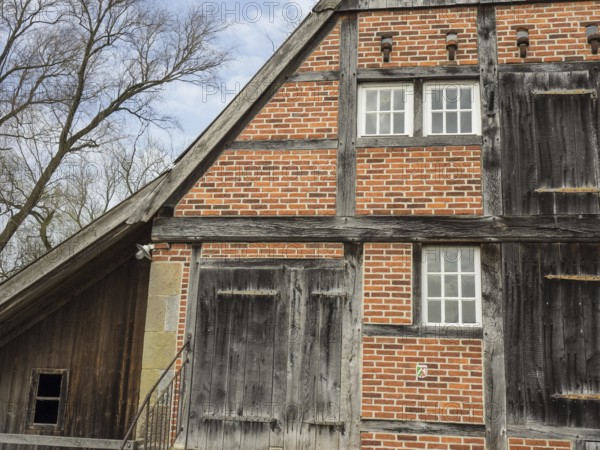 Rustic half-timbered house with striking wooden structure and red bricks, heek, münsterland,