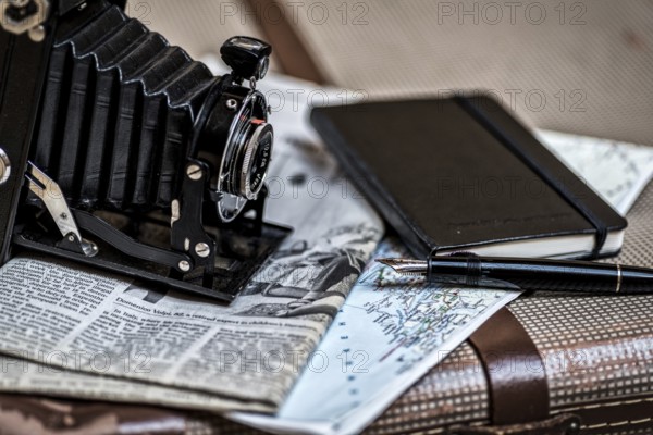 Still life with an old camera, pen, glasses and a road map in vintage style. Memories from
