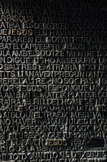 Detail with word Jesus on the bronze door of Passion facade of Sagrada Familia in Barcelona. The