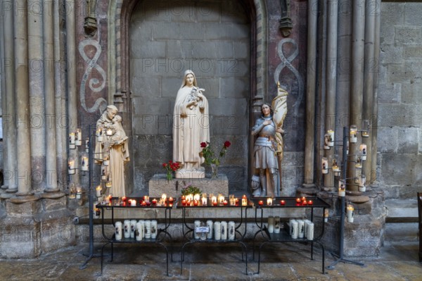 Dijon, France, 14 September, 2022: votive candles and altar in a side chapel of the Notre Dame of