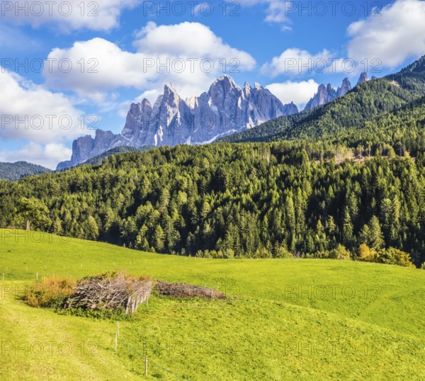 Warm autumn in the Dolomites, the Val de Funes. The valley is surrounded by a dentate wall of