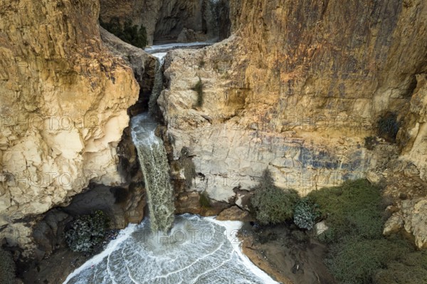 Powerful waterfall in the Judean Desert around the Dead Sea after heavy winter rains. Israel.