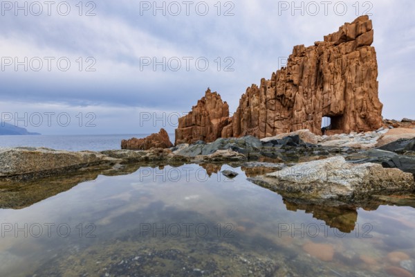 Rocce Rosse, the red rocks of Arbatax are reflected in a tidal pool, Arbatax, Tortoli, Ogliastra,