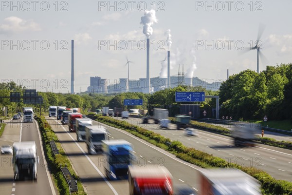Many lorries driving on the A2 motorway, in the background the Uniper coal-fired power plant