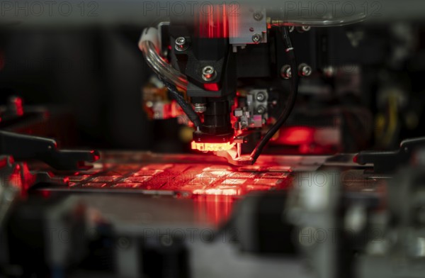 Robotic machine manufacturing semiconductor computer ship at a stall to show investors, during The