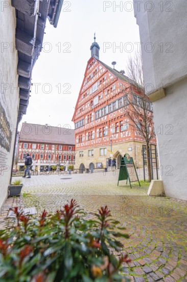 View of a red half-timbered house, town hall, through an alley with cobblestones, Großbottwar,