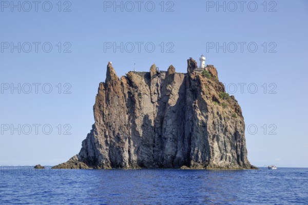 Rock island Strombolicchio with lighthouse, near island Stromboli, Lipari Islands, Tyrrhenian Sea,