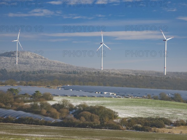 Solar park and wind farm near Breuna, with hoarfrost covered woodland in the background, North