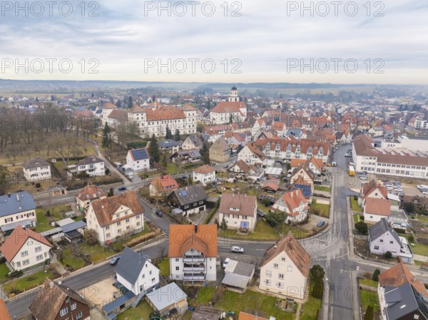 Overview of a charming town with a dominant church tower in the middle of a quiet neighbourhood,
