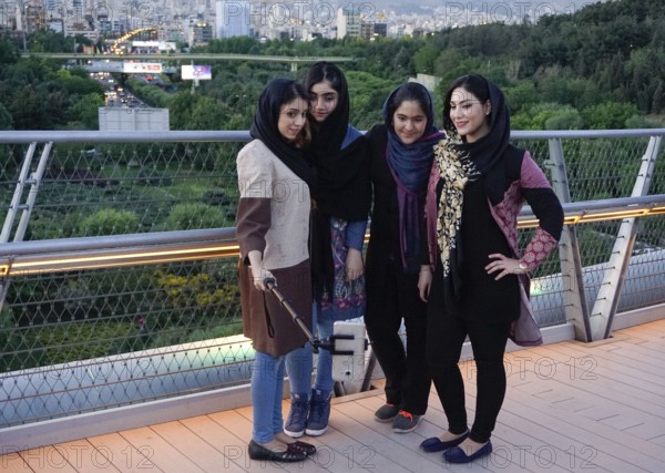 Women take selfie photos of themselves on the Tabiat Bridge in Tehran, Iran. The 270-metre-long