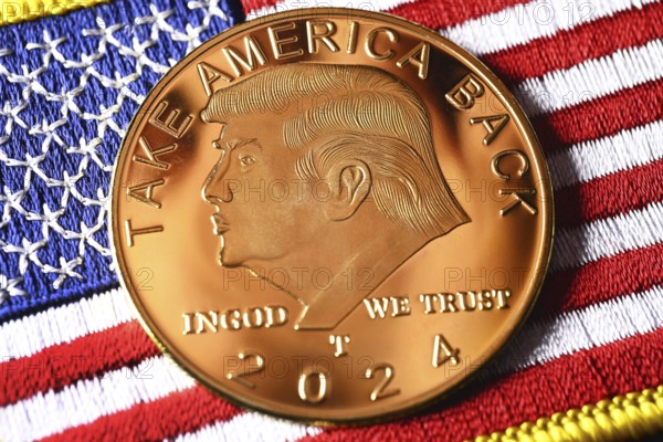 Election campaign coin with portrait of Donald Trump on USA flag, symbolic photo US presidential
