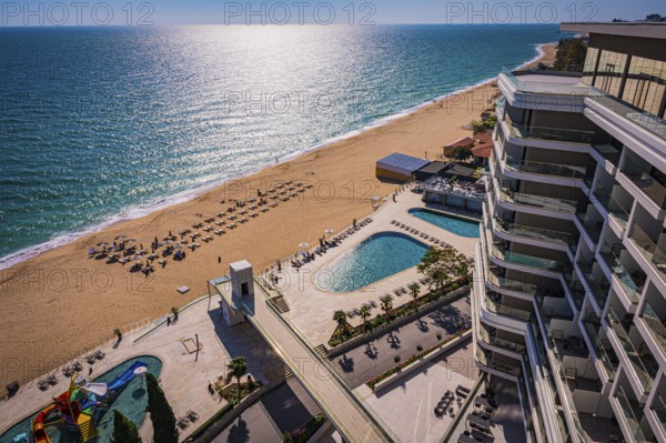 View of a hotel complex with pool on the beach, the Black Sea stretches into the distance, Golden