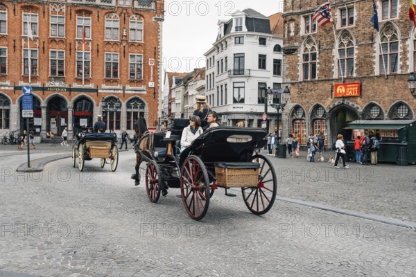 Bruges, Belgium, July 29, 2016: Horse carriage for tourists in Markt Square in the city of Bruges.