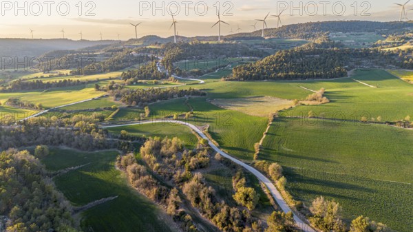 Aerial view of windmills on the hills between fields of cereal cultivation in the province of