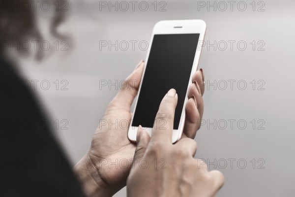 Cropped image of woman's hands holding smart phone with blank copy space screen for your text