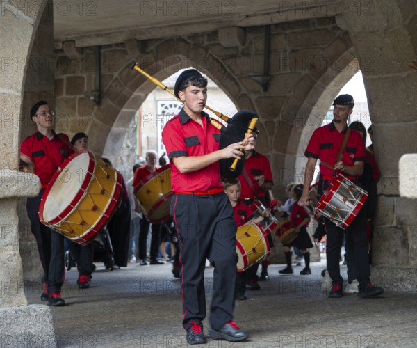 Traditional drum and pipe band perform on city streets on May Day 2025, Guimaraes, Braga district,
