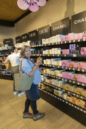 Woman shopping for perfume, Porto Duty Free shops, Aeroporto Francisco Sa Carneiro, Porto airport,