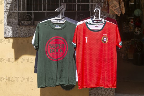 Super Bock brand t-shirt and replica national football shirt on display outside shop, Guimaraes,