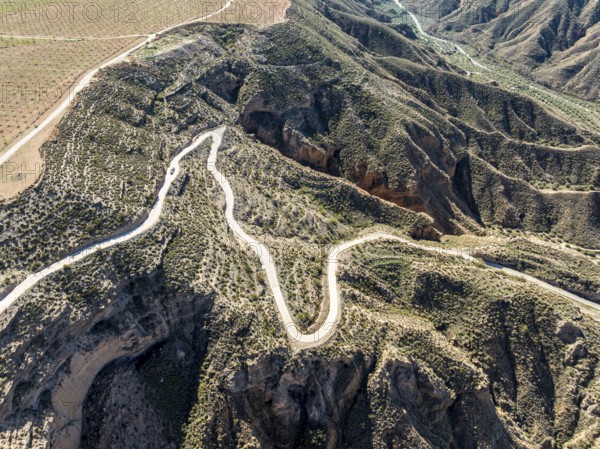 Canyons and gorges near village Gorafe, winding road, aerial view, Gorafe Desert, UNESCO Granada