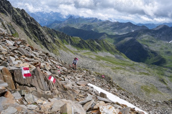 Red and white trail markings, hiker in the high mountains, Lasörling High Trail, Lasörling High