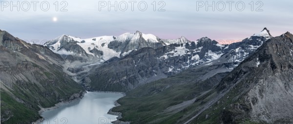 Mountain landscape with turquoise blue reservoir Lac des Dix and summit Mont Blanc de Cheilon, moon