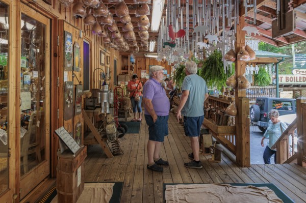 Senior men on the front porch of Bearmeats Indian Den arts, crafts and souvenir shop in Cherokee,