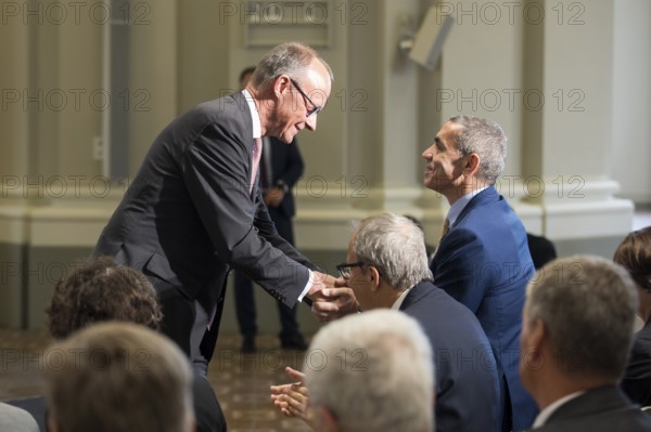 Friedrich Merz (Chancellor of the Federal Republic of Germany) congratulates Ugur Sahin (founder of