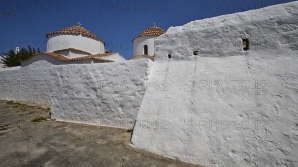 Church of Agia Kioura, White, rustic monastery building with domes under a clear sky, Church,