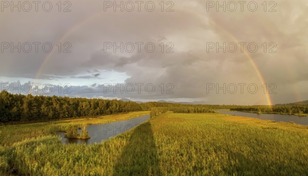 Complete and partial double rainbow in the Ainringer and Peracher moss nature reserve, Bavaria,