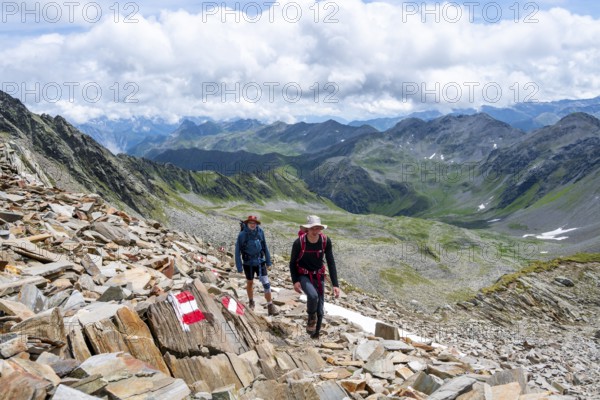 Red and white trail markings, hiker in the high mountains, Lasörling High Trail, Lasörling High