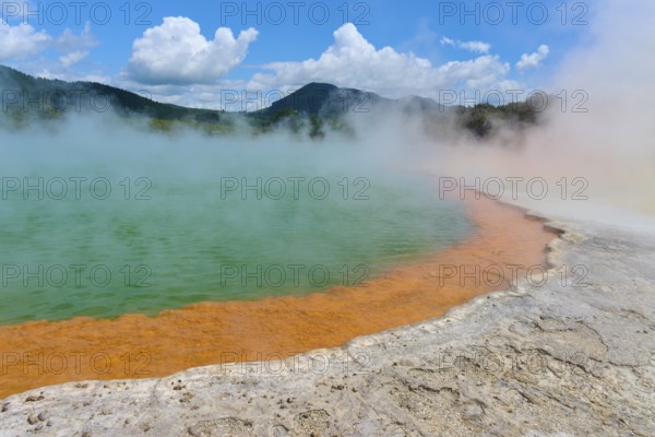 Bubbling mineral spring with steam and surrounded by mountains, Champagne Pool thermal lake,