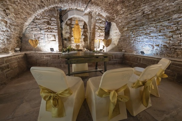 Ritual room in the historic cellar with chairs and decoration for a ceremony, family celebration in