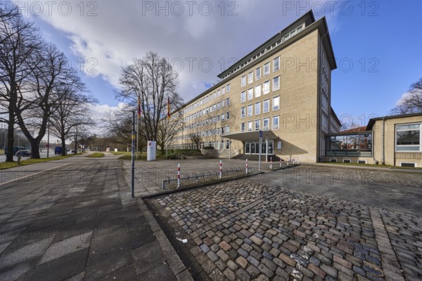 Tax office Hannover-Mitte, office building, pavement, paving slabs, bare wintry trees, blue sky,