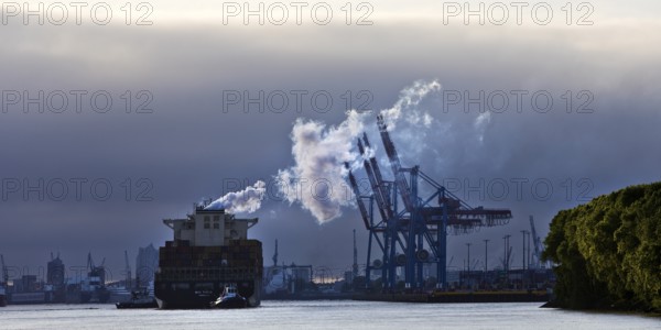 Container ship MSC Tokyo with two small tugs near the Burchardkai container terminal in the Port of