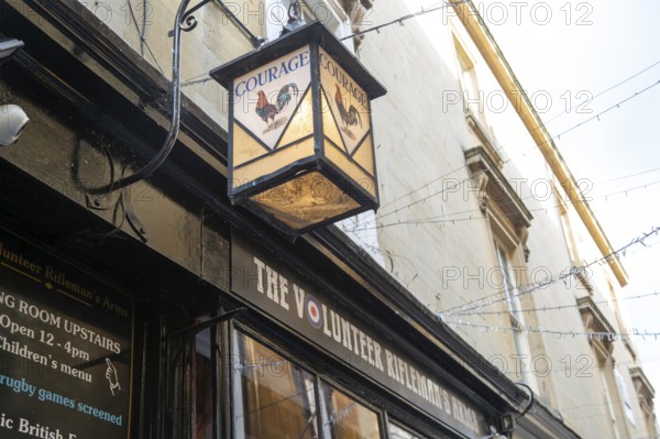 Vintage Courage pub lamp sign outside The Volunteer Rifleman's Arms pub, city of Bath, north east