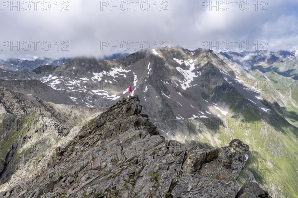 Hiker on a rock, Lasörling Höhenweg, Lasörling Group, Hohe Tauern National Park, East Tyrol, Tyrol,