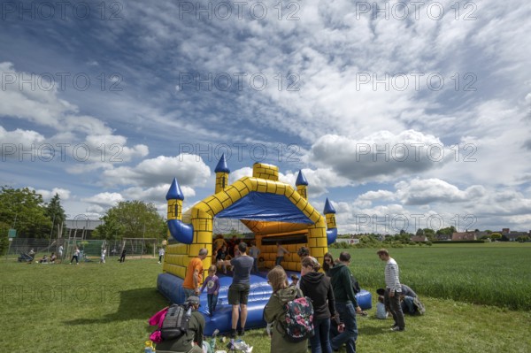 Children's fun, bouncy castle and football games in a meadow during the baking oven festival,
