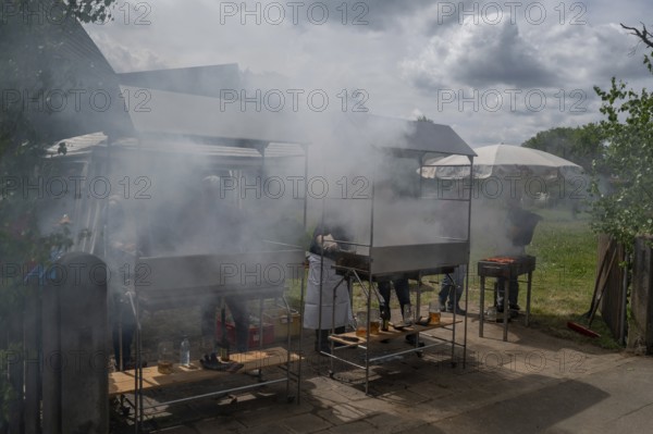 Heavy smoke at the sausage grill stations at the Backofenfest, Kleingeschaidt, Middle Franconia,