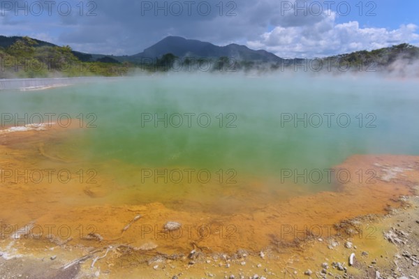 A geothermal area with steaming water and blue skies, Champagne Pool thermal lake, Wai-O-Tapu