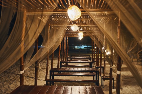 Empty beach restaurant lounge bar with lantern in the evening on tropical island. Summer vacation,