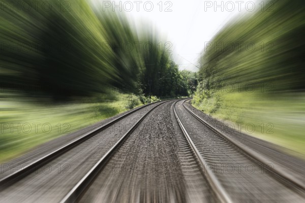 double-track railroad railway or train tracks with speed motion blur - fast travel concept