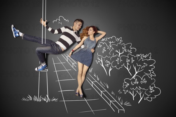 Happy Valentine's Day love story concept of a romantic couple against chalk drawings background.