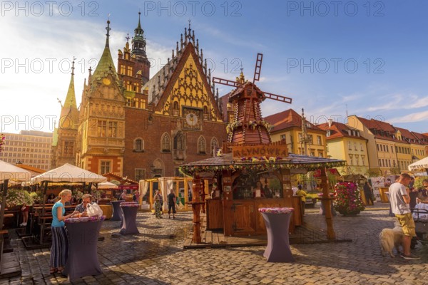 Wroclaw, Poland, June 21, 2019: Old Town Hall and decorative windmill at Market Square, stalls with