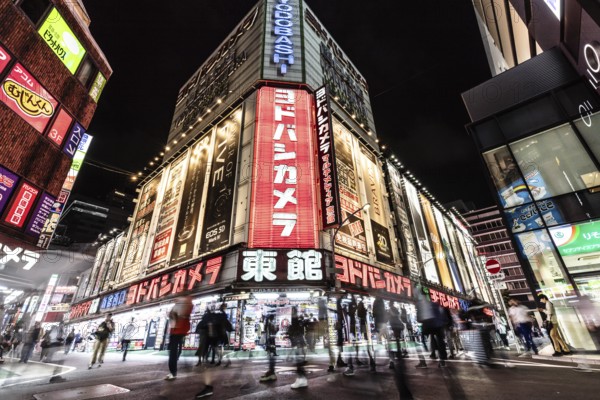TOKYO, JAPAN - MAY 18 2019: Neon signs illuminate Tokyo's busy Shinjuku neighborhood at night