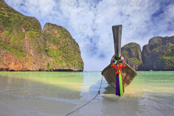 Scenic green islands of Thailand coast. Emerald sea and fine white sand. On the beach approached by