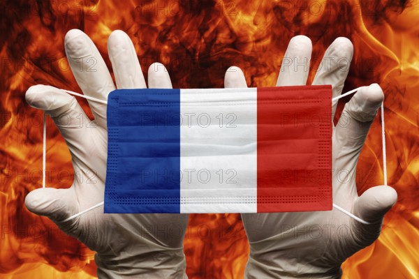 Doctor holding in white gloves protection medical face mask, respiratory bandage with France