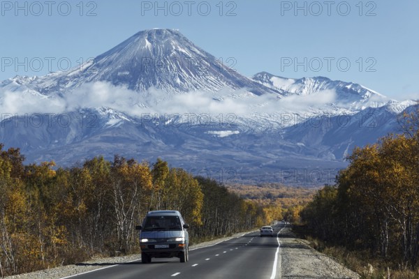 KAMCHATKA, RUSSIA, SEP 30, 2012: Autumn view of cars on driving road to active Avachinsky Volcano