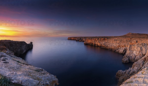 Landscape view of cliffs and rugged shorelina at Pont d'en Gil in northeastern Menorca near