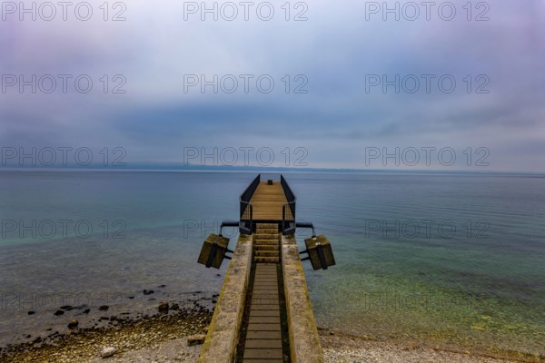 Waterfront and a Pier on Lake Neuchatel in Old Town in a Foggy Winter day in City of Neuchatel,