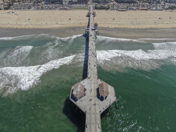 Aerial view of Huntington Pier, beach and coastline during sunny summer day, Southeast of Los